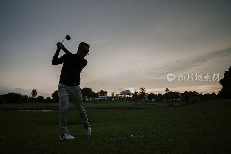 an asian chinese mature guy tee off swing his driver club at tee off point golf course in weekend